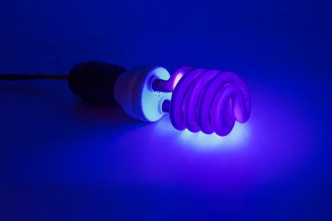 Compact UV - ultraviolet CCFL - Cold Cathode Fluorescent Lamp on white surface Stock Photos