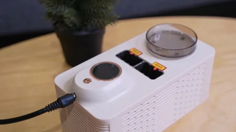 Compact White Electronic Appliance on Table Stock Footage 341717857