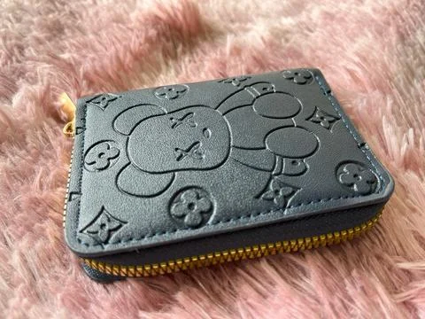 Compact zippered wallet with character pattern Stock Photos