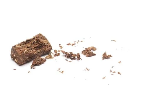 Compacted dried marijuana isolated over white background. Фото