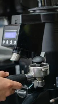 Compacting coffee with tamper Stock-Fotos