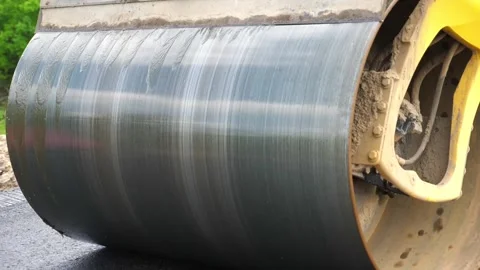 Compactor constructing highway. Steamroller slowly ride. Roadway repair work Stock Footage 287176503