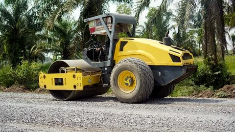 Compactor or vibrator roller or vibro roller is leveling soil, gravel and r.. Stock Photos