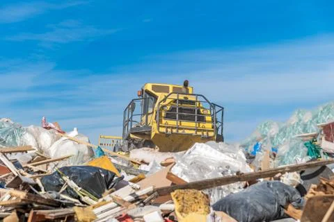 Compactor processes waste at a landfill Stock-Fotos