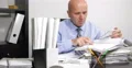 Company Accounting Manager Man Calculate Payment Documents Using Adding Machine 4k or 4k+ Resolution