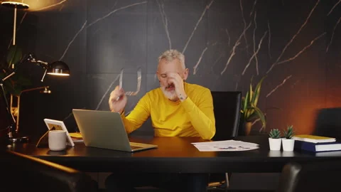 Company boss feeling stressed while working on a laptop, financial problems Stock Footage 340902739