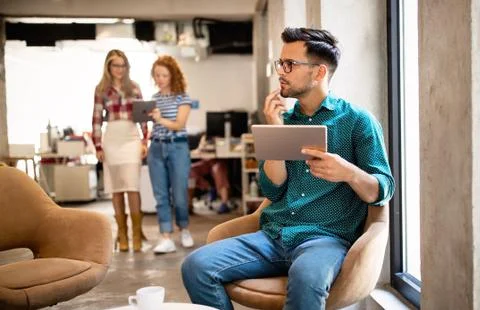Company employees working in software development and designer office Stock Photos