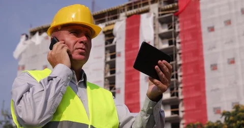 Company Engineer Inspect Construction Site Talking Phone and Use Tablet Stock Footage 83665170