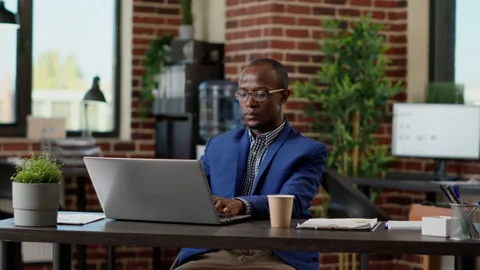 Company manager analyzing network information on laptop Stock Footage 196066261