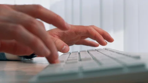 Company manager is typing on a computer keyboard in an office Stock Footage 128598786