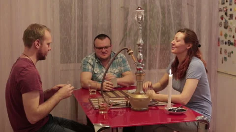 Company people smoking shisha and talking Stock Footage 59574177