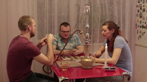 Company smokes hookah and talking Stock Footage 59573571