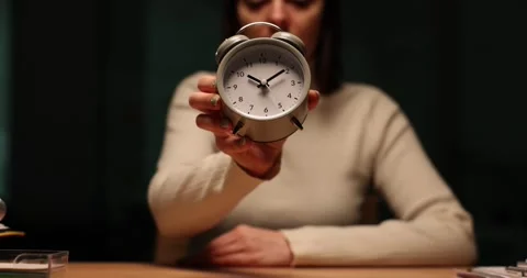 Company worker shows alarm clock at Stock Video Pond5 - Main Image