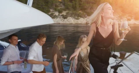 Company of Young Girls and Boy in Fahionable Clothes Leave Yacht To Party.  Stock Footage