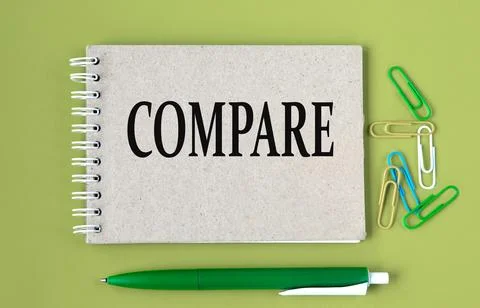 COMPARE - word on a gray notebook with pen and paper clips Stock Photos