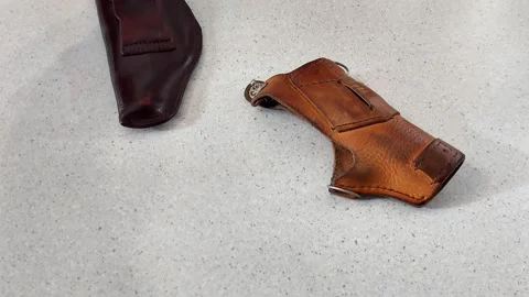Comparing Leather Holsters: Dark vs Light Wear and Clip Detail Stock Footage 322151110
