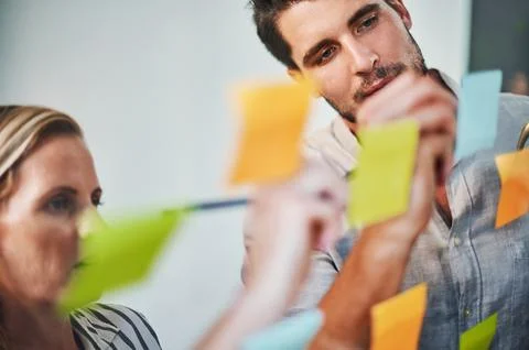 Comparing notes and coming up with ideas. two business colleagues brainstorming Stock Photos