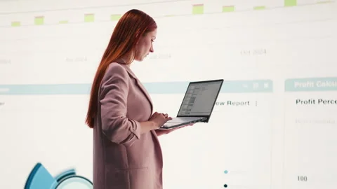 Comparing profit data, laptop and businesswoman using charts Stock Footage 330030392