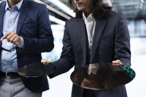 Comparing semiconductor substrates, microchip factory and closeup of businessmen Stock Photos