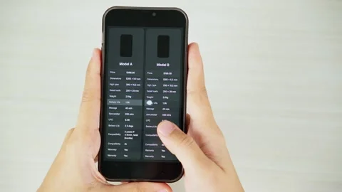 Comparing Two Products on Smartphone From Top View Video stock 347178771
