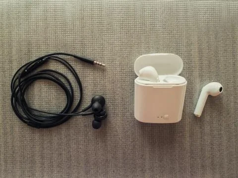 Comparison between 3.5mm jack wired headphones vs wireless earphones for musi Stock Photos