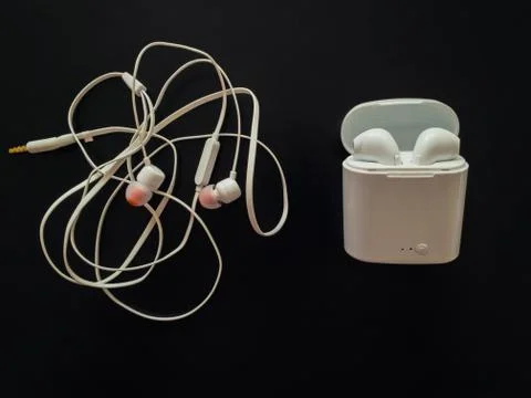 Comparison between tangled wired headphones versus wireless earphones for mus Stock Photos