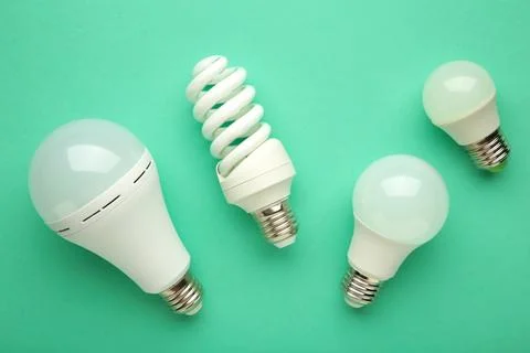 Comparison of different light bulbs on mint background Stock Photos
