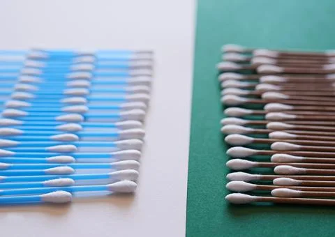 A comparison of eco-friendly and plastic cotton buds flat lay Stock Photos