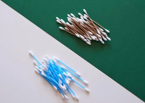 A comparison of eco-friendly and plastic cotton buds flat lay Stock Photos
