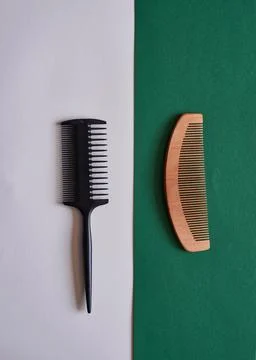 A comparison flat lay of plastic and wooden eco-friendly comb Stock Photos