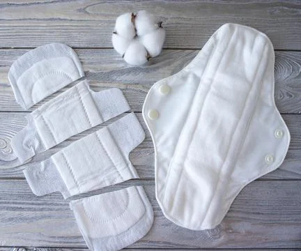 Comparison of reusable pads and cut disposable pads. Reusable concept. Stock Photos