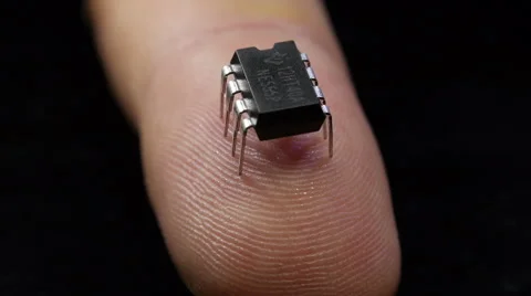 Comparison of the size of the crystal silicon chip with the chip - slow rotation Stock Footage 42638307