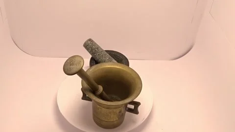 Comparison video of vintage brass mortar and modern granite mortar Stock Footage 337026015