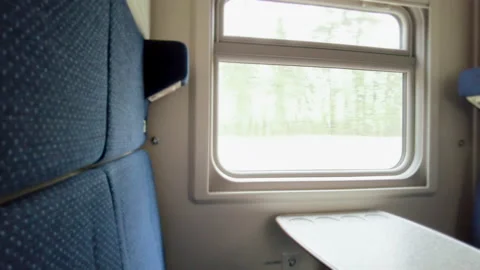 The compartment window of a train, the nature behind the window, the movement of Stock Footage 163667157