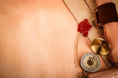 Compass, ancient scroll with red wax seal on old paper as a background Stock Photos