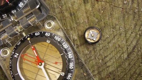 Compass and Button Compass. Compasses for Wilderness Survival Stock Footage 306513848