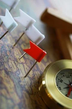 Compass and Flag Pins on a Map - Travel Planning, Navigation, Adventure Conce Stock Photos