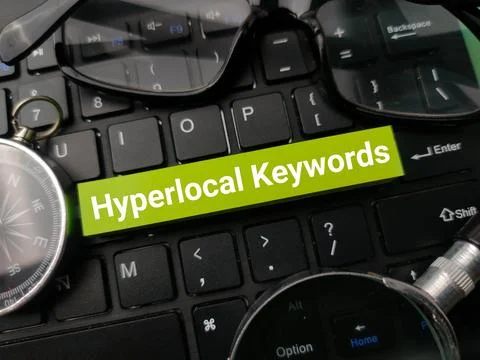 Compass and glasses with the word Hyperlocal Keywords on a black keyboard b.. Stock Photos