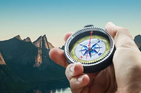 Compass and hand in mountains Foto stock