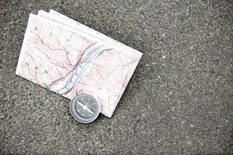 Compass and map on the asphalt Stock Photos