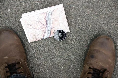 Compass and map on the asphalt Stock Photos