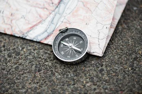 Compass and map on the asphalt Stock Photos
