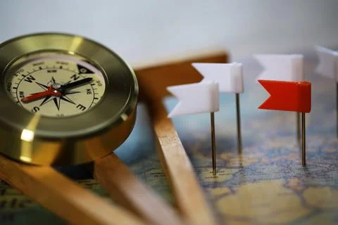 Compass and Map with Flag Pins - Navigational Tools for Travel and Exploratio Stock Photos