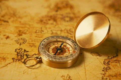 Compass on and map table. Vintage style. Selective focus. Stock Photos