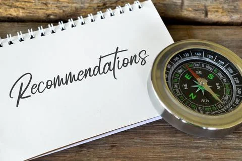 Compass and notebook written with text RECOMMENDATIONS. Stock Photos