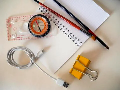 A compass and objects on a white background Stock Photos