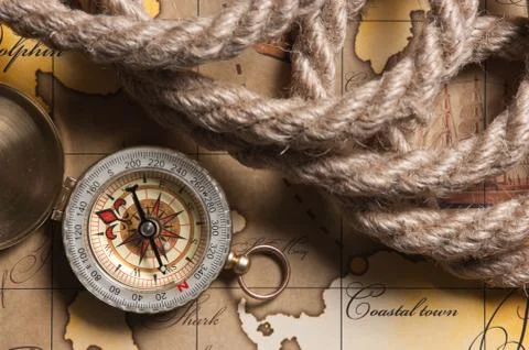 Compass and rope on map Stock Photos