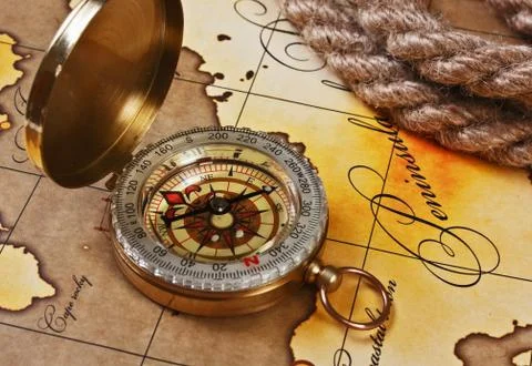 Compass and rope on map Stock Photos