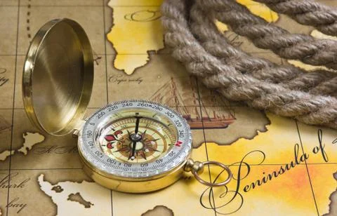 Compass and rope on map Stock Photos