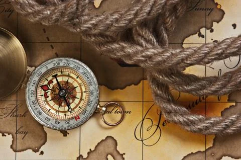 Compass and rope on map Stock Photos